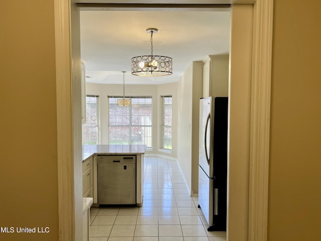 8004 Martin Bluff Rd, Gautier, MS 39553 - kitchen with dishwasher, freestanding refrigerator, a chandelier, light tile patterned floors, and a peninsula