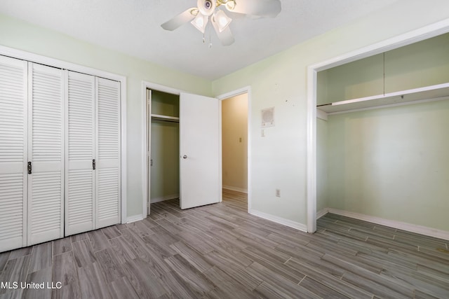 unfurnished bedroom featuring a ceiling fan, wood finished floors, and baseboards