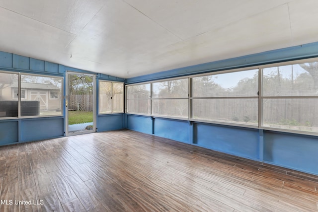 unfurnished sunroom with vaulted ceiling