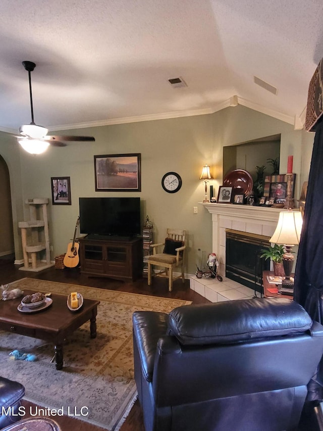 8475 Windersgate Dr, Olive Branch, MS 38654 - living room with a tiled fireplace, vaulted ceiling, ornamental molding, and a ceiling fan