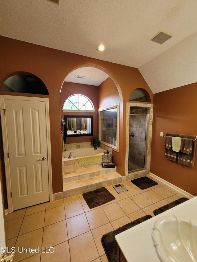 8475 Windersgate Dr, Olive Branch, MS 38654 - bathroom with a bath, a textured ceiling, a sink, tile patterned flooring, and tiled shower