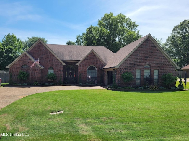 8475 Windersgate Dr, Olive Branch, MS 38654 - view of front of property featuring brick siding, a front lawn, curved driveway, and roof with shingles