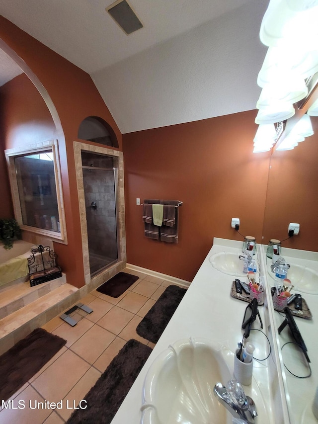 8475 Windersgate Dr, Olive Branch, MS 38654 - full bathroom with lofted ceiling, tile patterned flooring, a stall shower, double vanity, and baseboards