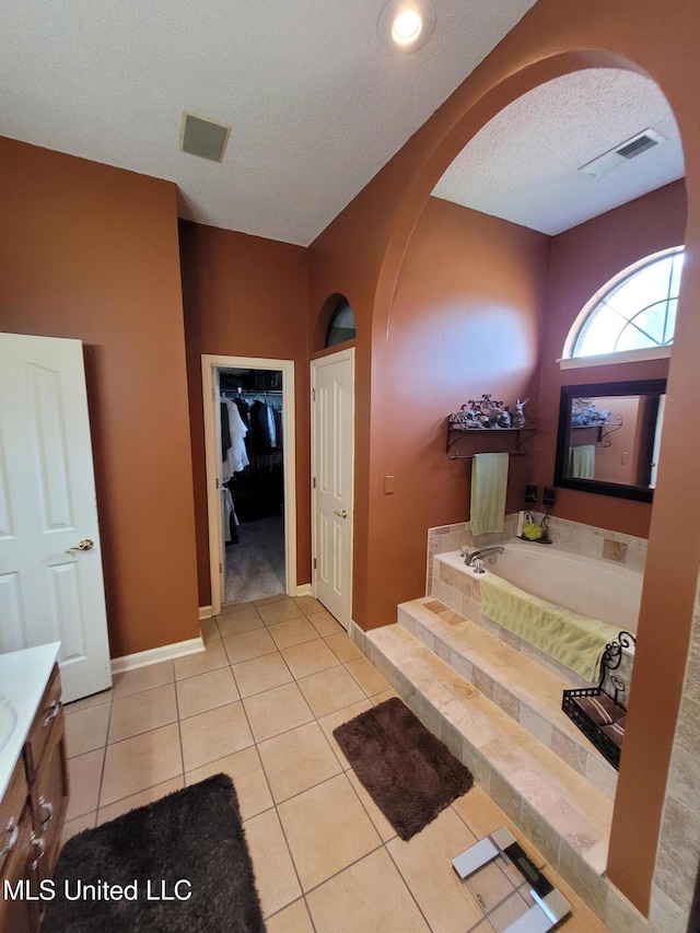 8475 Windersgate Dr, Olive Branch, MS 38654 - full bath with a bath, vanity, a textured ceiling, tile patterned floors, and baseboards