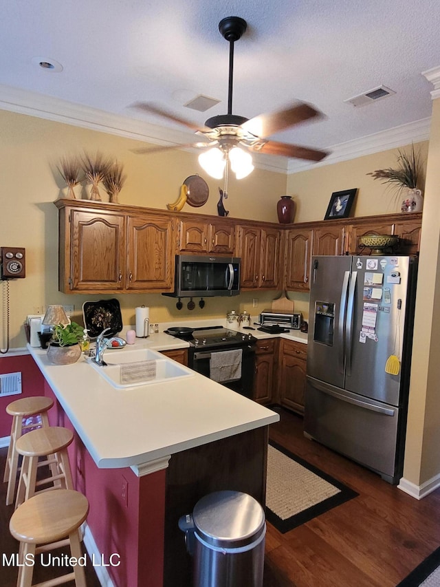8475 Windersgate Dr, Olive Branch, MS 38654 - kitchen featuring stainless steel appliances, a peninsula, a sink, a kitchen breakfast bar, and light countertops