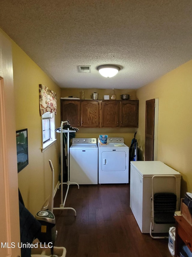 8475 Windersgate Dr, Olive Branch, MS 38654 - washroom featuring cabinet space, washer and clothes dryer, dark wood-style flooring, and a textured ceiling
