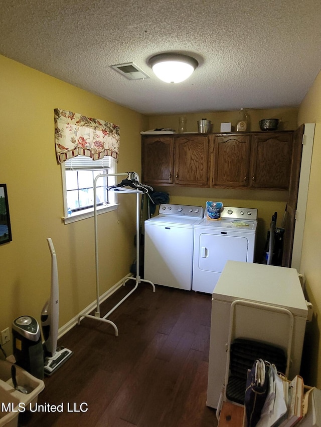8475 Windersgate Dr, Olive Branch, MS 38654 - washroom featuring cabinet space, washer and clothes dryer, dark wood finished floors, a textured ceiling, and baseboards