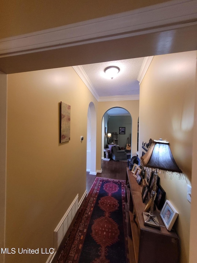 8475 Windersgate Dr, Olive Branch, MS 38654 - hall featuring arched walkways, ornamental molding, wood finished floors, and baseboards