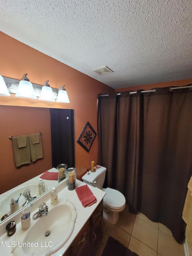 8475 Windersgate Dr, Olive Branch, MS 38654 - full bathroom featuring vanity, toilet, tile patterned floors, a textured ceiling, and a shower with shower curtain