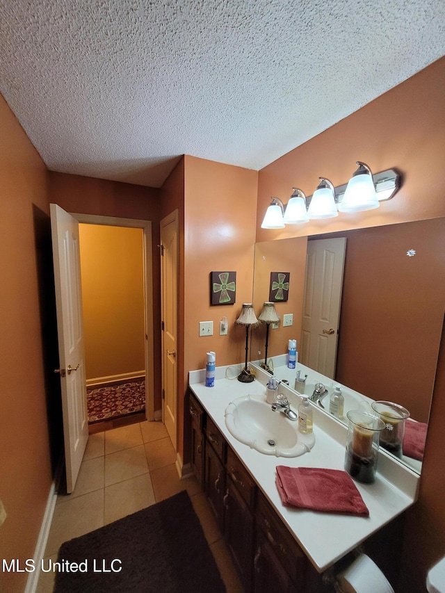 8475 Windersgate Dr, Olive Branch, MS 38654 - bathroom with vanity, a textured ceiling, tile patterned flooring, and baseboards