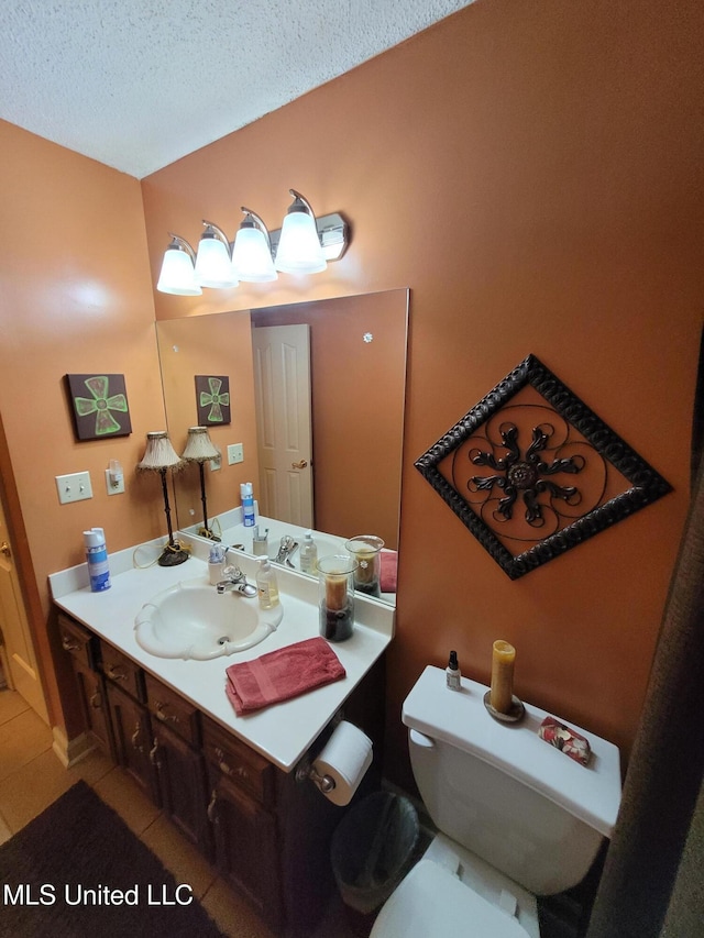 8475 Windersgate Dr, Olive Branch, MS 38654 - bathroom with tile patterned floors, vanity, toilet, and a textured ceiling