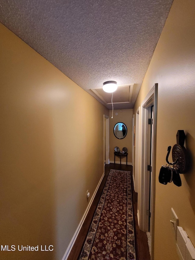 8475 Windersgate Dr, Olive Branch, MS 38654 - corridor featuring attic access, a textured ceiling, and baseboards