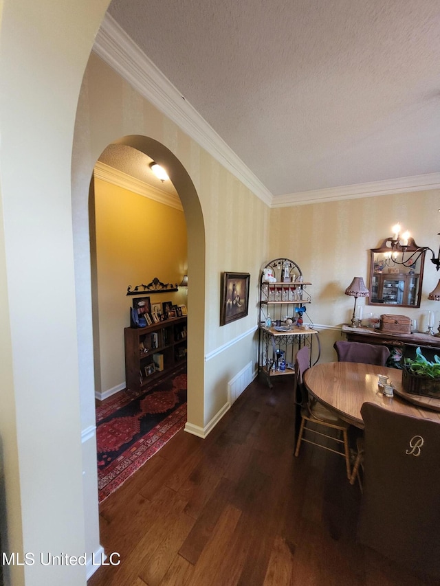 8475 Windersgate Dr, Olive Branch, MS 38654 - dining room with arched walkways, wood finished floors, ornamental molding, a textured ceiling, and wallpapered walls