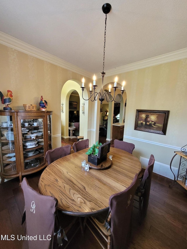8475 Windersgate Dr, Olive Branch, MS 38654 - dining space featuring arched walkways, wood-type flooring, ornamental molding, wallpapered walls, and baseboards