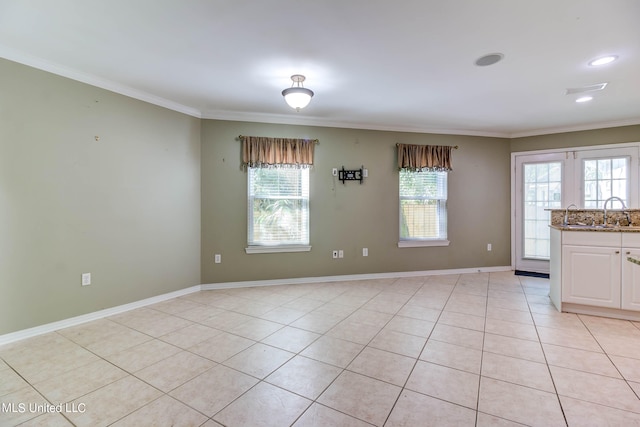 interior space featuring a healthy amount of sunlight, ornamental molding, and light tile patterned floors