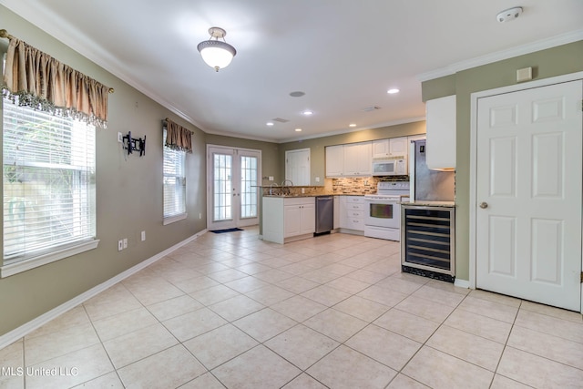 kitchen featuring beverage cooler, light tile patterned floors, backsplash, white cabinetry, and white appliances