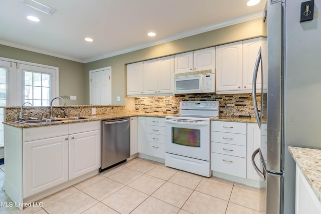 kitchen featuring light stone countertops, sink, kitchen peninsula, stainless steel appliances, and white cabinets