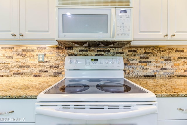 kitchen with white cabinetry, tasteful backsplash, light stone counters, and white appliances