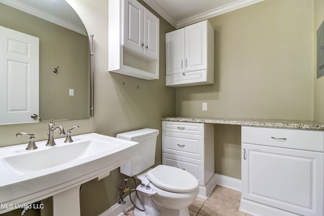 bathroom with toilet, ornamental molding, sink, and tile patterned flooring