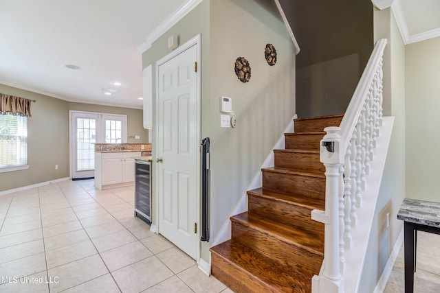 stairway featuring crown molding, sink, beverage cooler, and tile patterned flooring