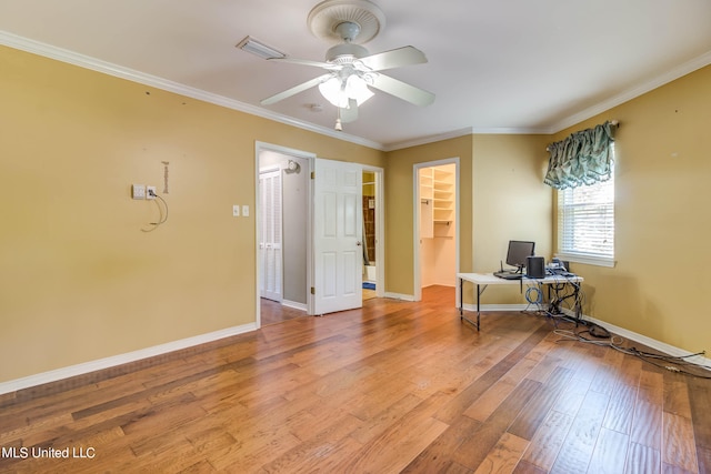 unfurnished office featuring ornamental molding, hardwood / wood-style flooring, and ceiling fan