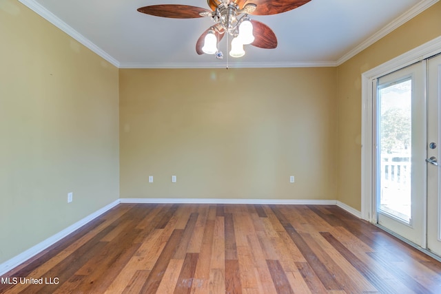 empty room featuring french doors, ornamental molding, hardwood / wood-style flooring, and ceiling fan