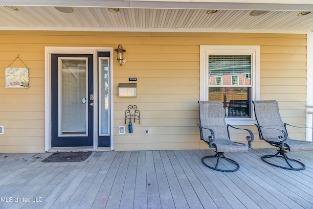 property entrance featuring a wooden deck