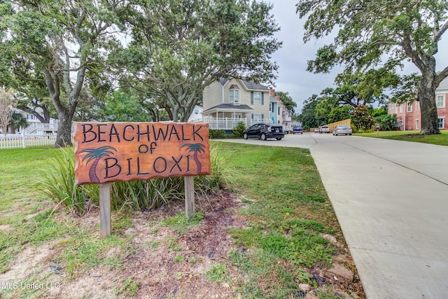 community / neighborhood sign with a lawn