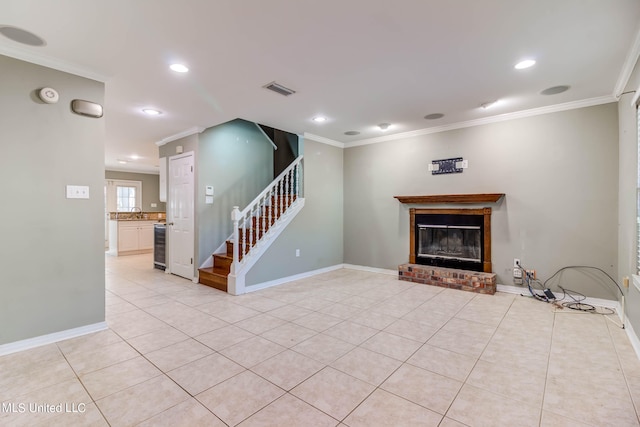 unfurnished living room featuring wine cooler, ornamental molding, light tile patterned floors, and a brick fireplace