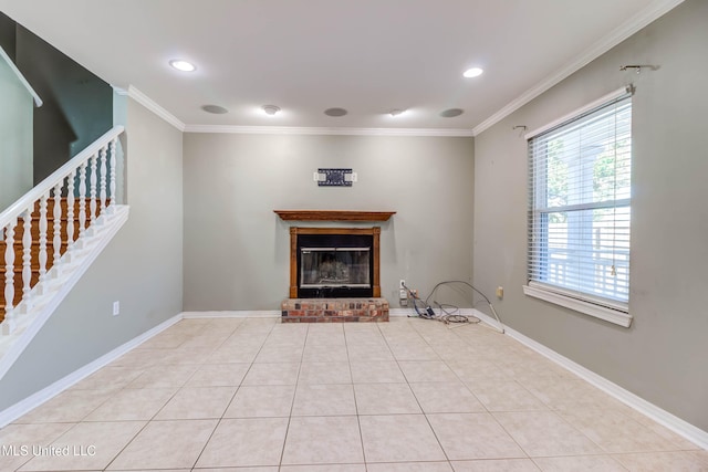 unfurnished living room with crown molding, a fireplace, and light tile patterned floors