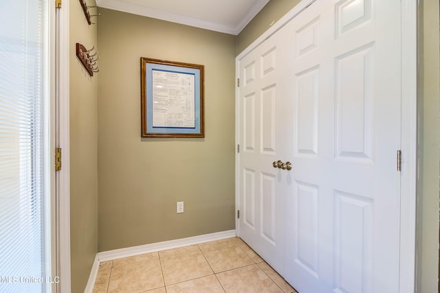 corridor featuring ornamental molding and light tile patterned floors