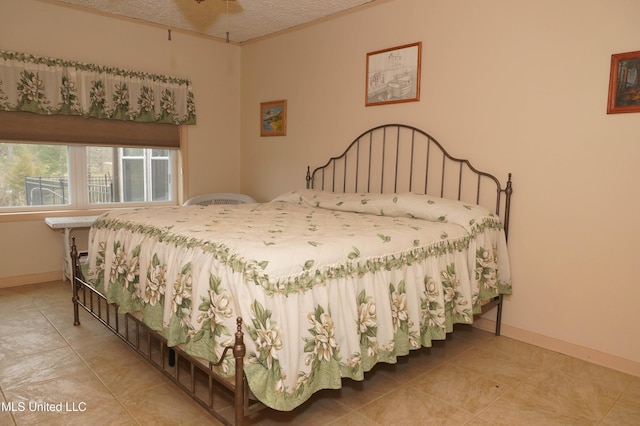 bedroom featuring ceiling fan and a textured ceiling