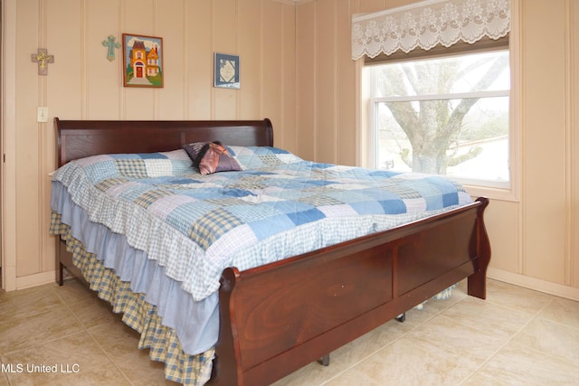 bedroom with multiple windows and light tile patterned floors