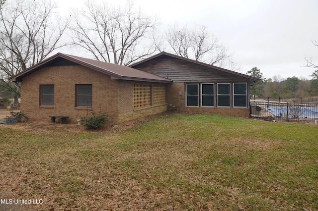 rear view of property featuring a yard