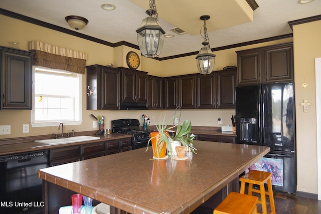 kitchen featuring black appliances, crown molding, sink, decorative light fixtures, and dark brown cabinetry