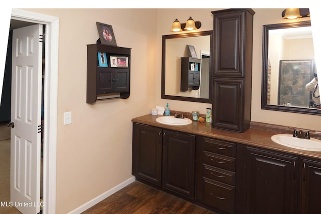 bathroom featuring vanity, wood-type flooring, and crown molding