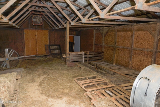 miscellaneous room featuring wooden walls and lofted ceiling