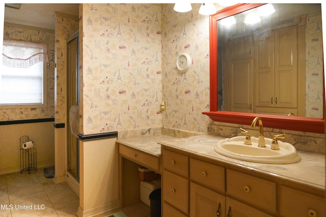 bathroom featuring vanity, tile patterned floors, and a shower with door