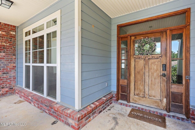 view of exterior entry with covered porch