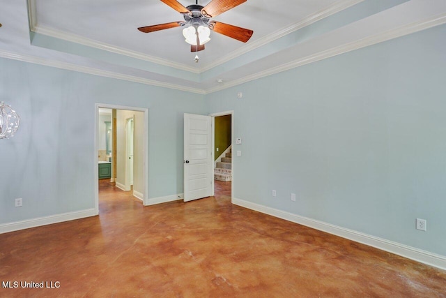 unfurnished bedroom with baseboards, ornamental molding, concrete floors, and a raised ceiling