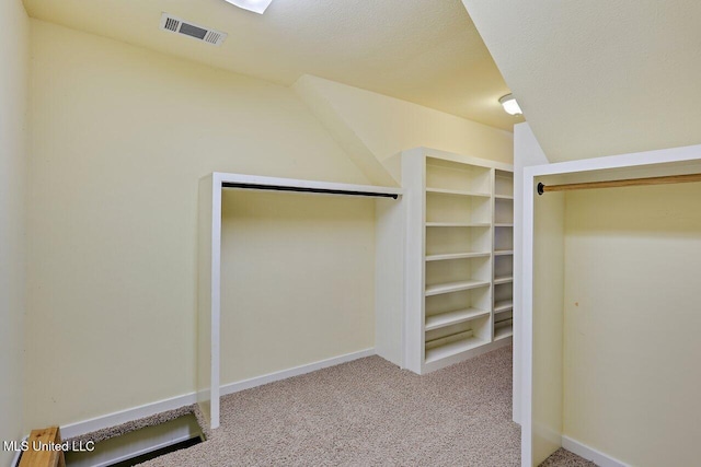 walk in closet with carpet floors and visible vents
