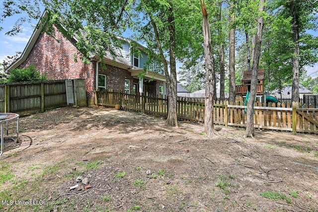 view of yard with a fenced backyard and a playground