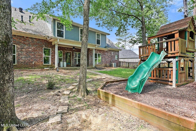view of jungle gym featuring ceiling fan, fence, and central AC