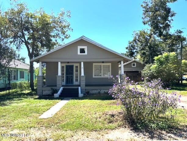 bungalow-style home featuring a front yard and a porch