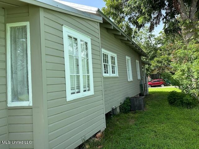 view of side of home with a lawn