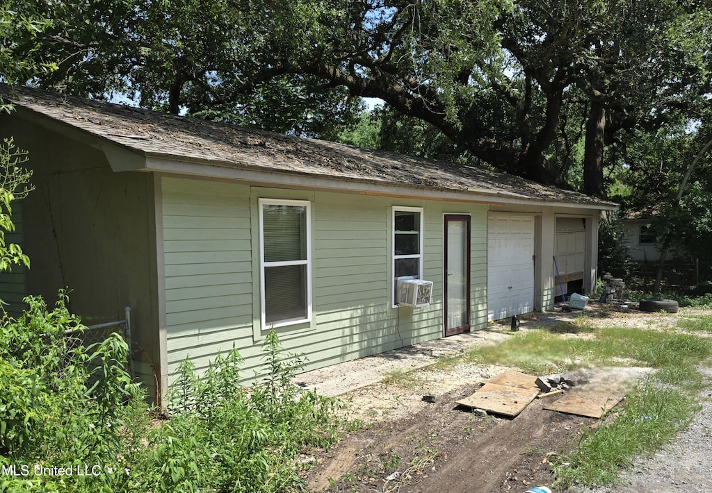 2227 5th Ave, Gulfport, MS 39501 - view of property exterior with a detached garage, an outdoor structure, and cooling unit