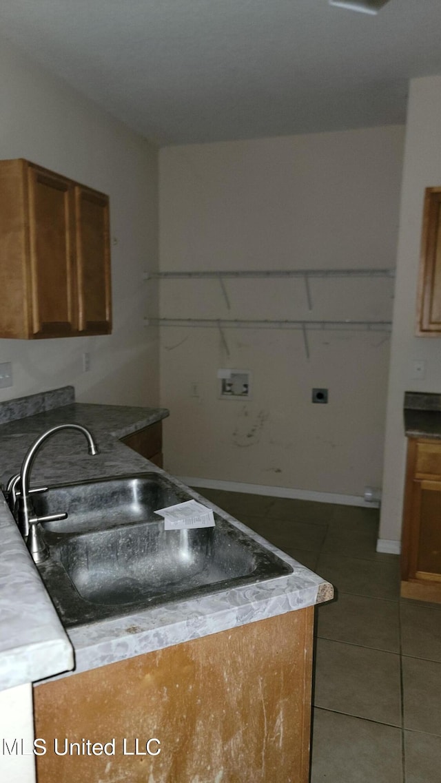 kitchen with tile patterned floors and sink