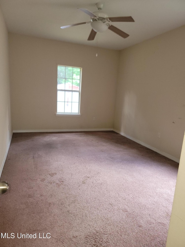 unfurnished room with carpet and ceiling fan