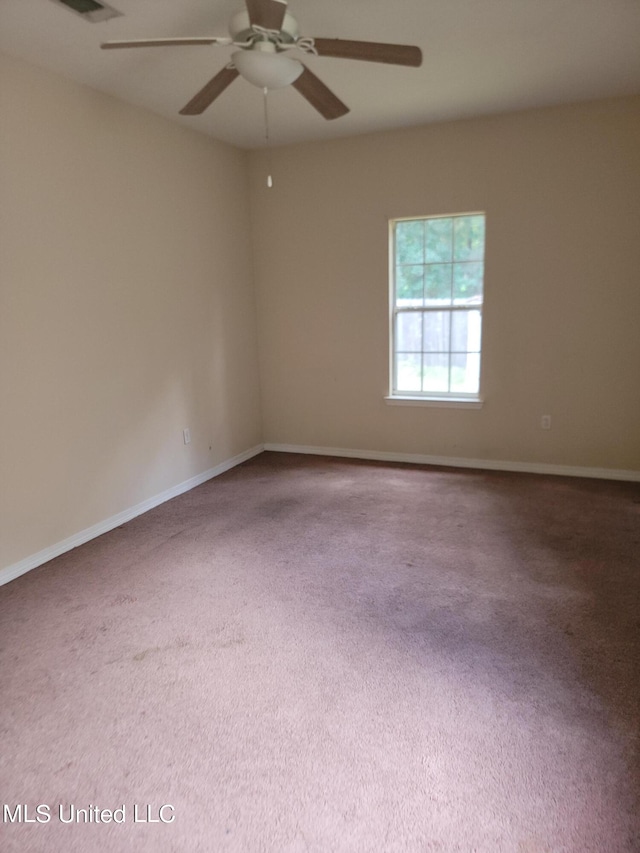 spare room featuring carpet floors and ceiling fan