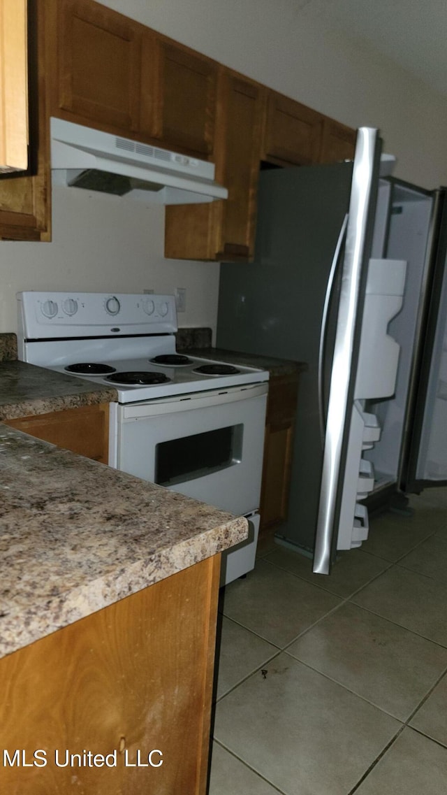 kitchen featuring white range with electric stovetop and tile patterned floors